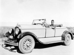 1925 Studebaker Roadster with Donald Hall in the driver seat with the license plate showing