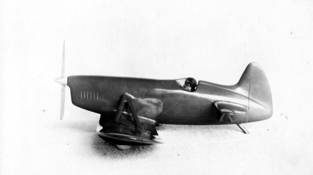 Vintage black and white closeup side view photograph of the proposed production gull wing aircraft model with a stabilator that was designed by Donald Hall, taken on the roof of the old Ryan factory in San Diego, California.