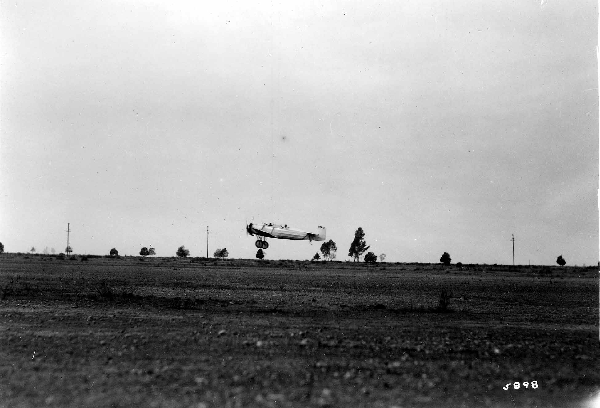 A vintage black and white photograph of the testing of the Hall X-1. The airplane was designed by chief engineer Donald A. Hall in 1929. Testing was at Camp Kearney in San Diego, California, and was the same location where the Spirit of St. Louis was tested. Currently, this is the site of Marine Corps Air Station Miramar.  The aircraft has an early patented all-moving tail, which is similar to the stabilator. The airplane was built by the Donald A. Hall Aeronautical Development Company.