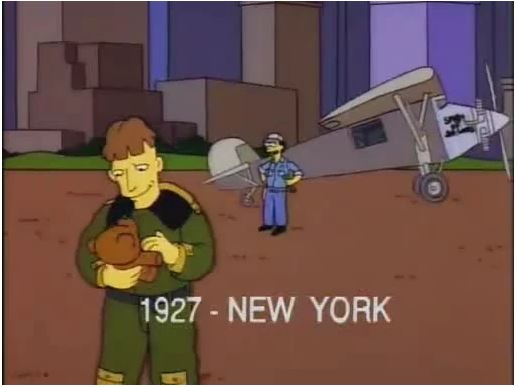 Screenshot from the Simpsons episode "Rosebud" where Charles Lindbergh stands in front of his Spirit of St. Louis aircraft before he was to make his non-stop Atlantic flight in 1927, holding a teddy bear.